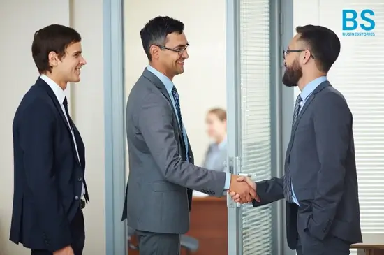 How to build trust as a client relationship partner shown through a professional handshake in an office, highlighting strong business relationships and communication.