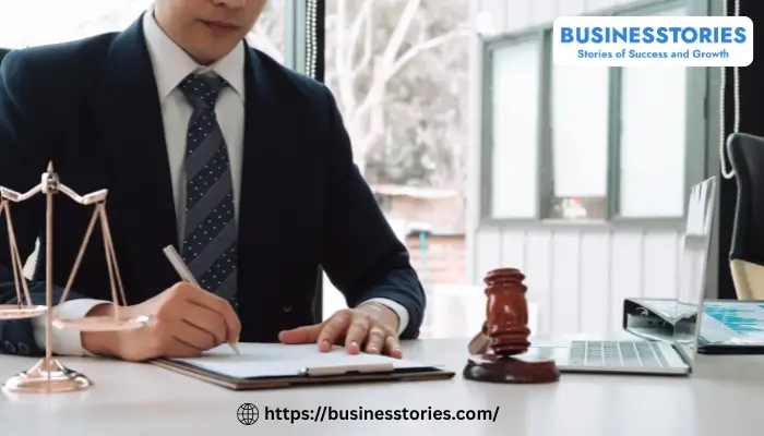 Entrepreneur signing legal business documents with law symbols representing business law for startups and small businesses.